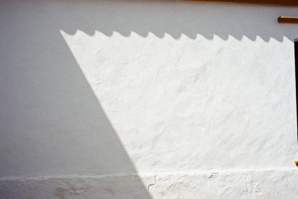 White Wall in Seville at The Flat Glare Of Noon Light in in Seville, Spain