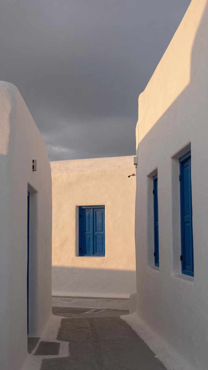 Whitewashed Cycladic House Blue Shutters Sunset in inside a skylit passageway in Callao