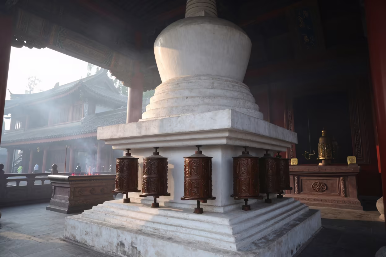 Whitewashed Stupa Prayer Wheels at Chongqing Altar in at the foot of a stone altar in Chongqing