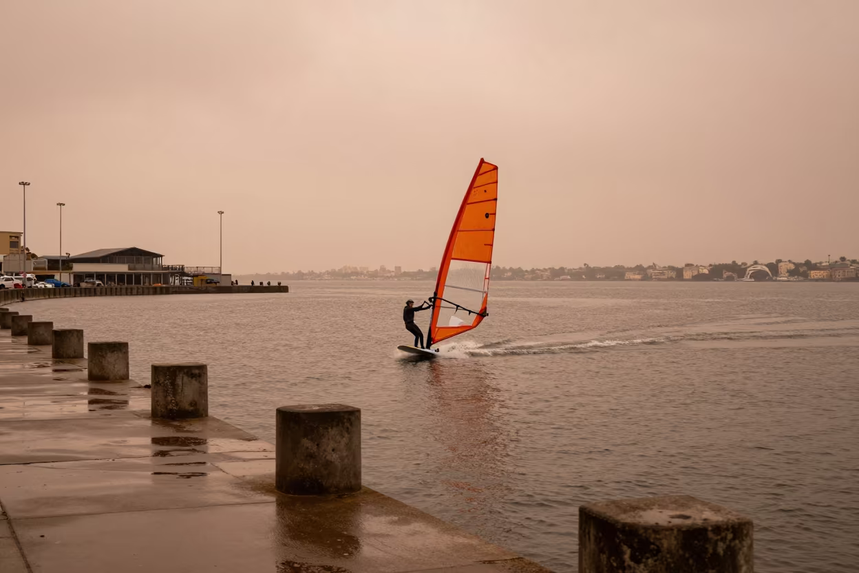 Windsurfer Planing Across Harbor Quay Water in at a harbor quay near Amman
