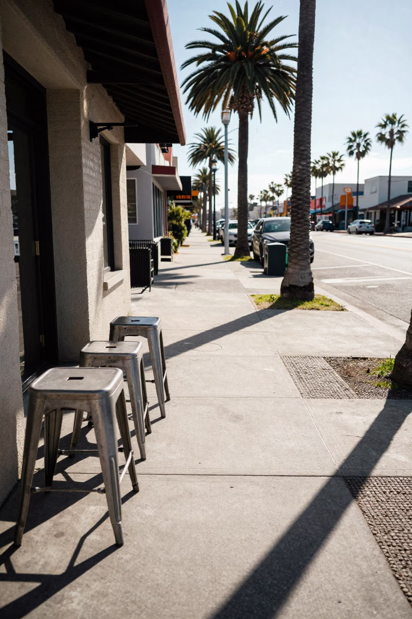 Winter Noon Sunlight on San Diego Street with Metal Stools and Quilt in in San Diego, California, United States