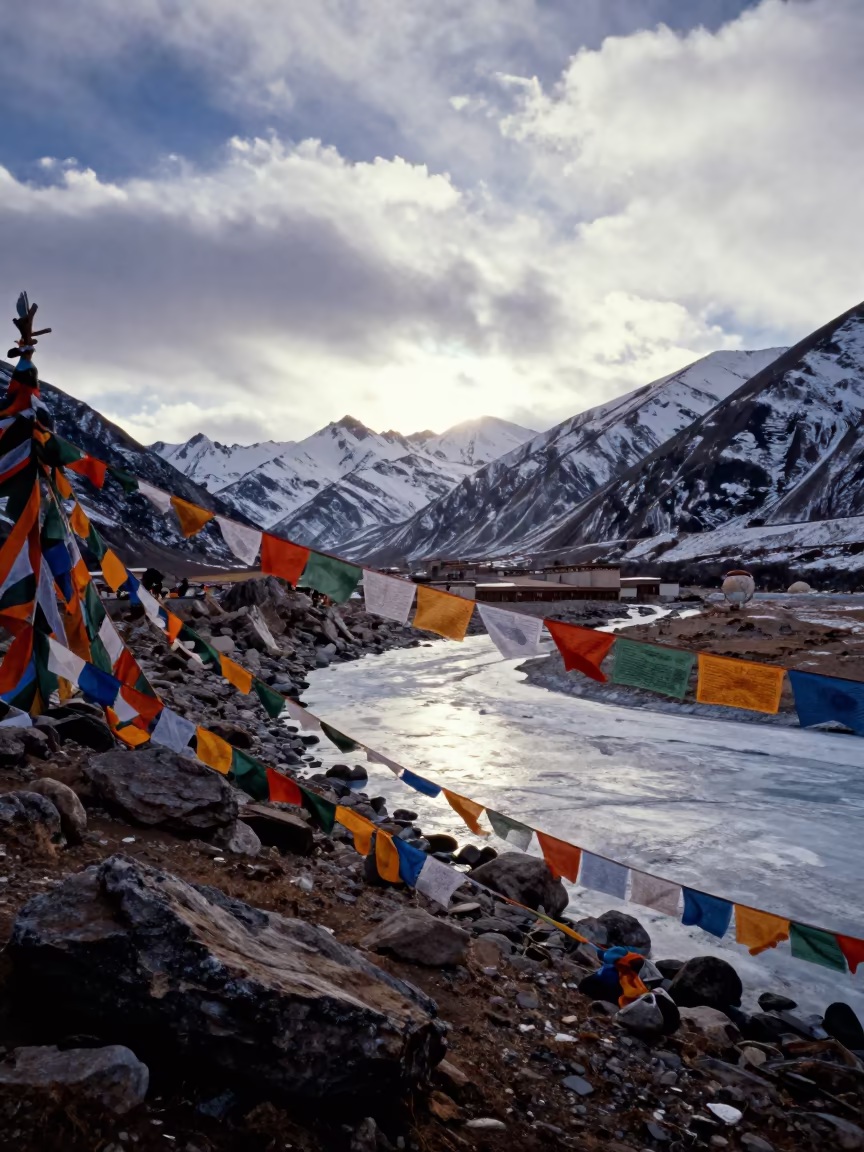 Winter Prayer Flags Over Lhasa Valley in at a rocky saddle overlooking a mountain valley near Lhasa