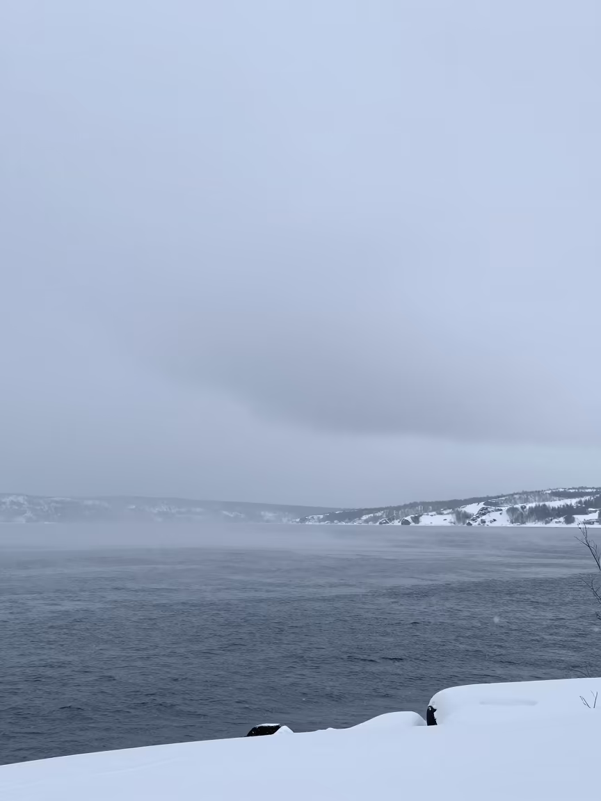 Winter Snow Squall Over Murmansk Lake Horizon in over a horizon of stacked thunderheads near Murmansk