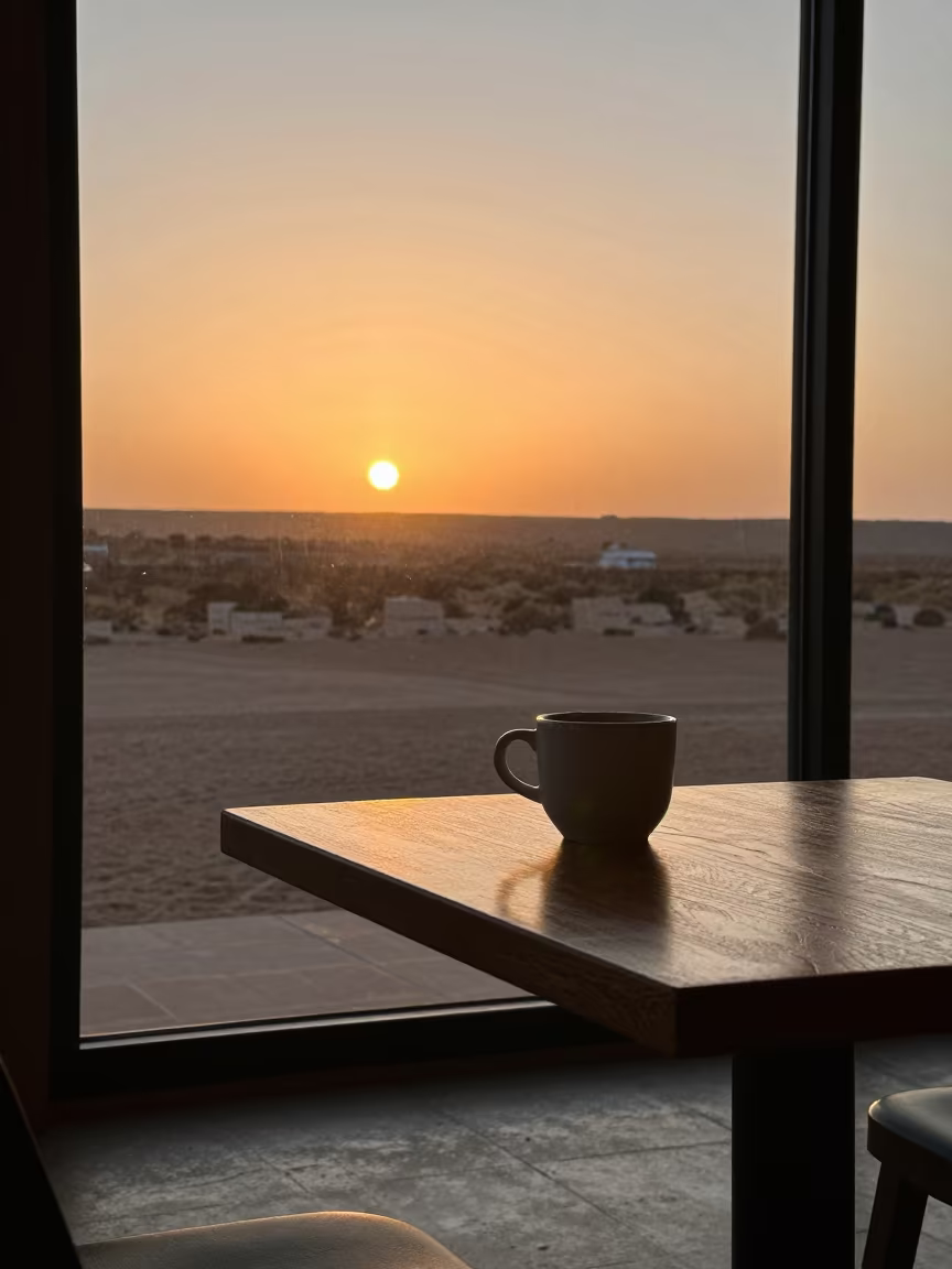 Winter Solstice Sun Rising Over Nazca Cafe in on a cafe table by a window in Nazca
