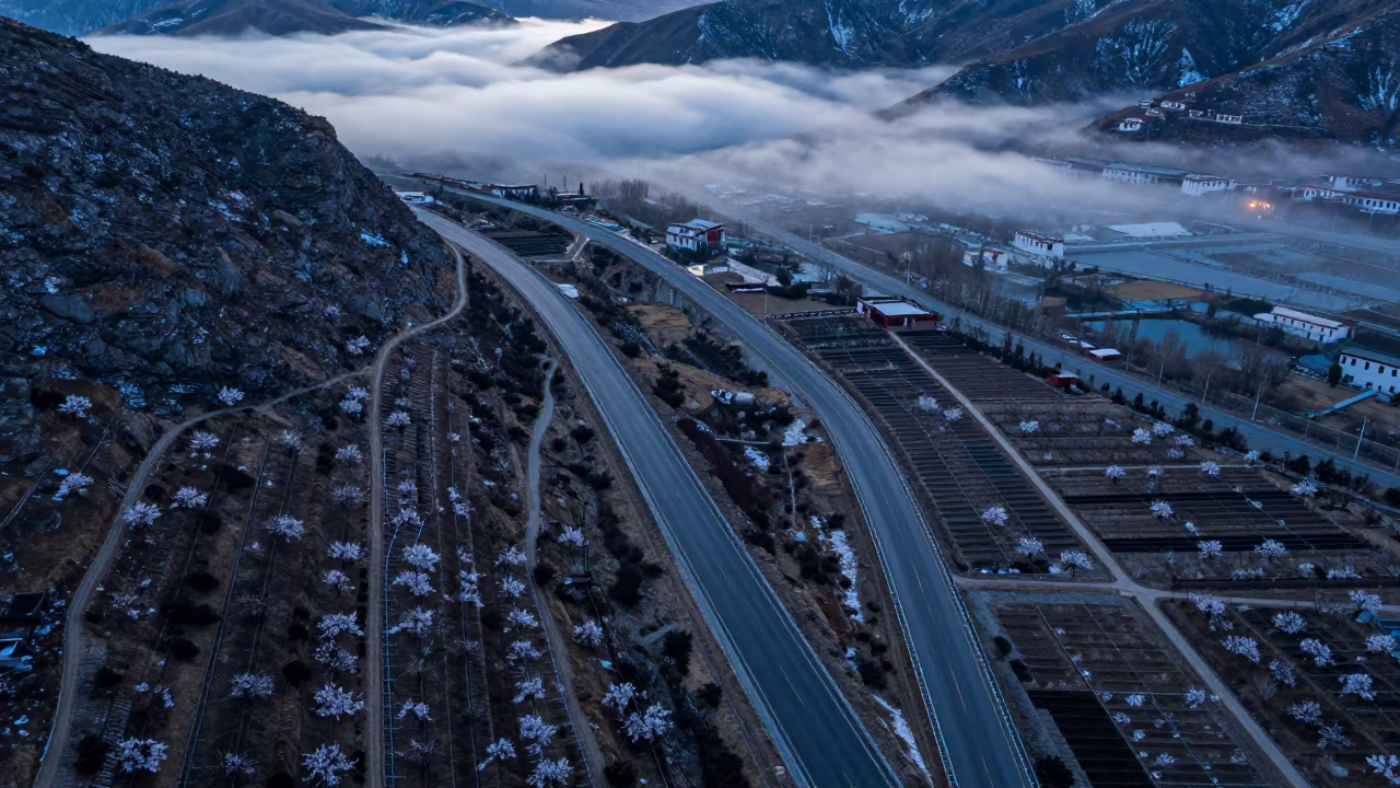 Winter Twilight Coastal Highway Cliff Aerial View in far above orchard blocks and irrigation lines near Potala, Lhasa