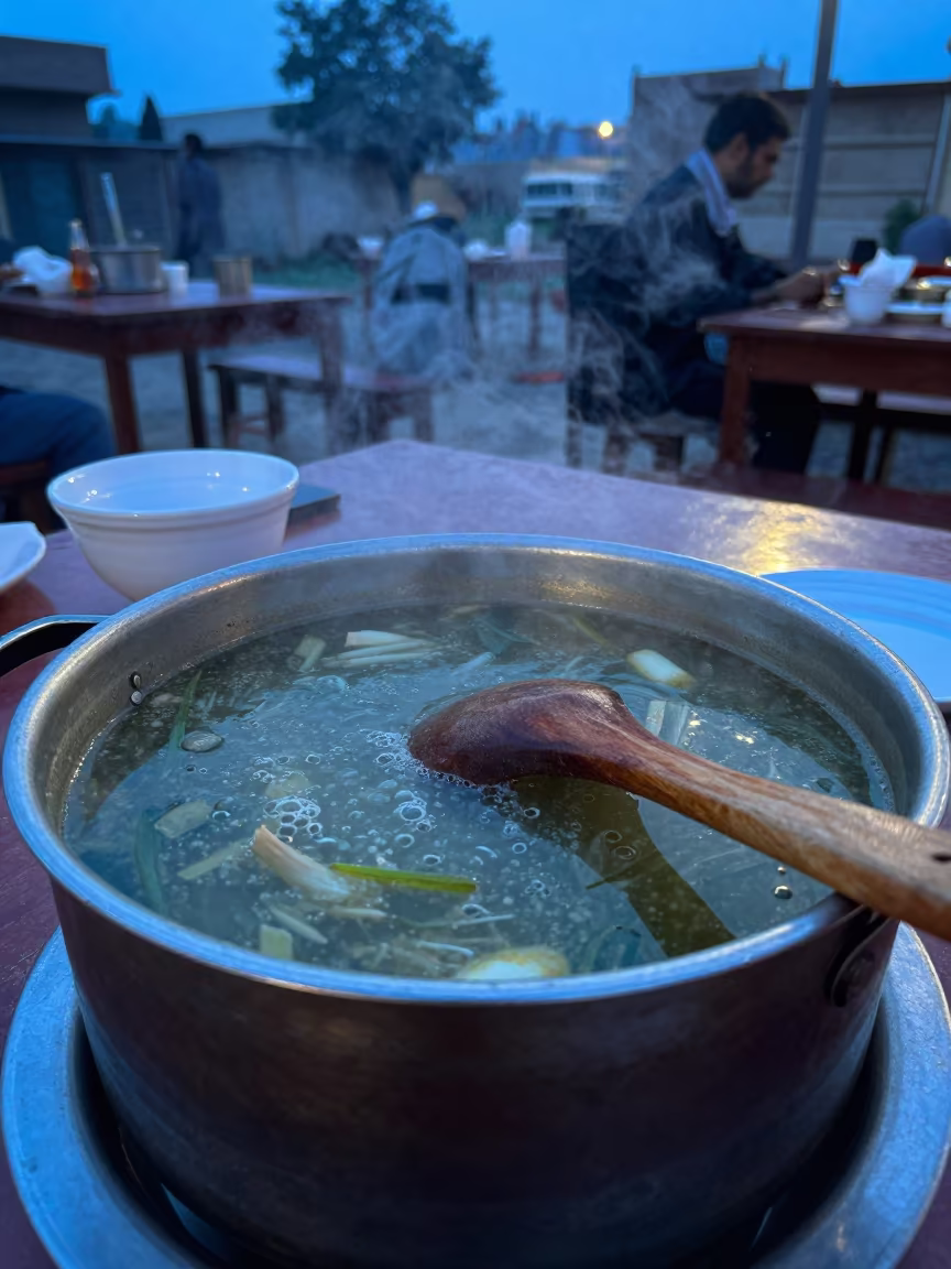 Wooden Spoon Resting on Simmering Soup Pot in on a restaurant table in Bahawalpur
