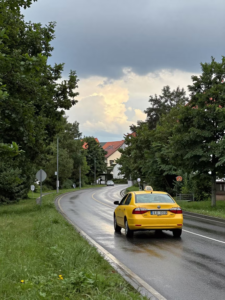 Yellow Taxi on Ljubljana Switchback in Rain in along a switchback approach near Ljubljana