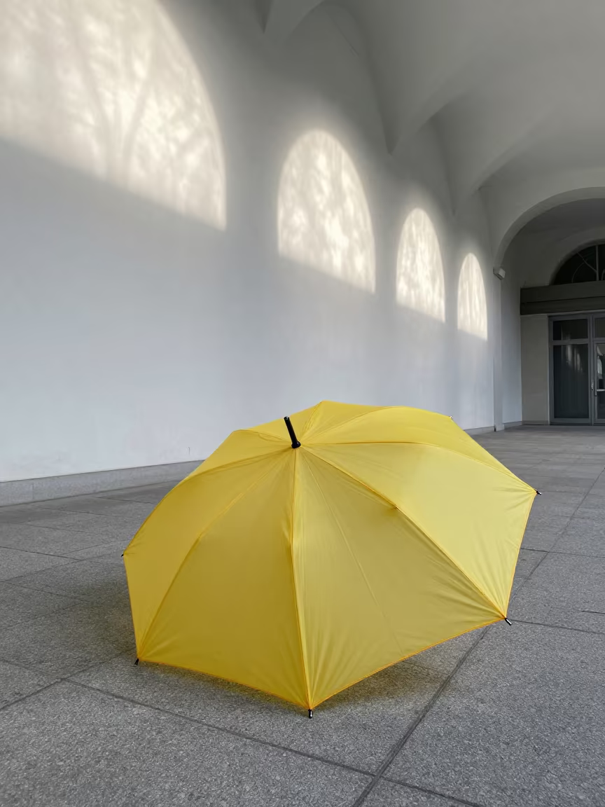 Yellow Umbrella on Grey Pavement Atrium in inside a vaulted atrium near Piacenza