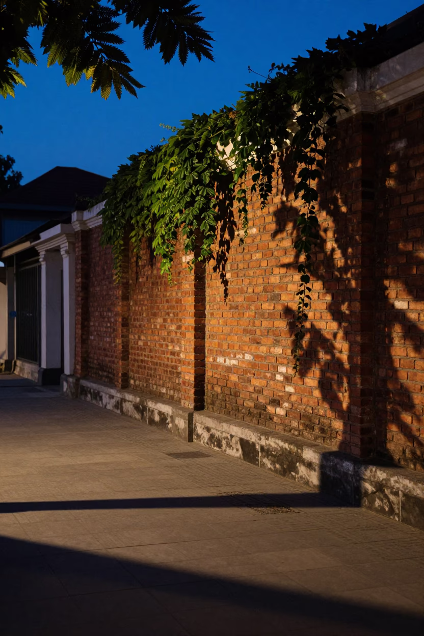 Yogyakarta Blue Hour Street Scene with Leaf Shadows and Brick Wall Ivy in in Yogyakarta, Indonesia