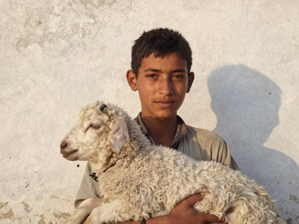 Young Shepherd Lamb Shoulder Portrait Mosul in against a sun-bleached plaster wall near Mosul