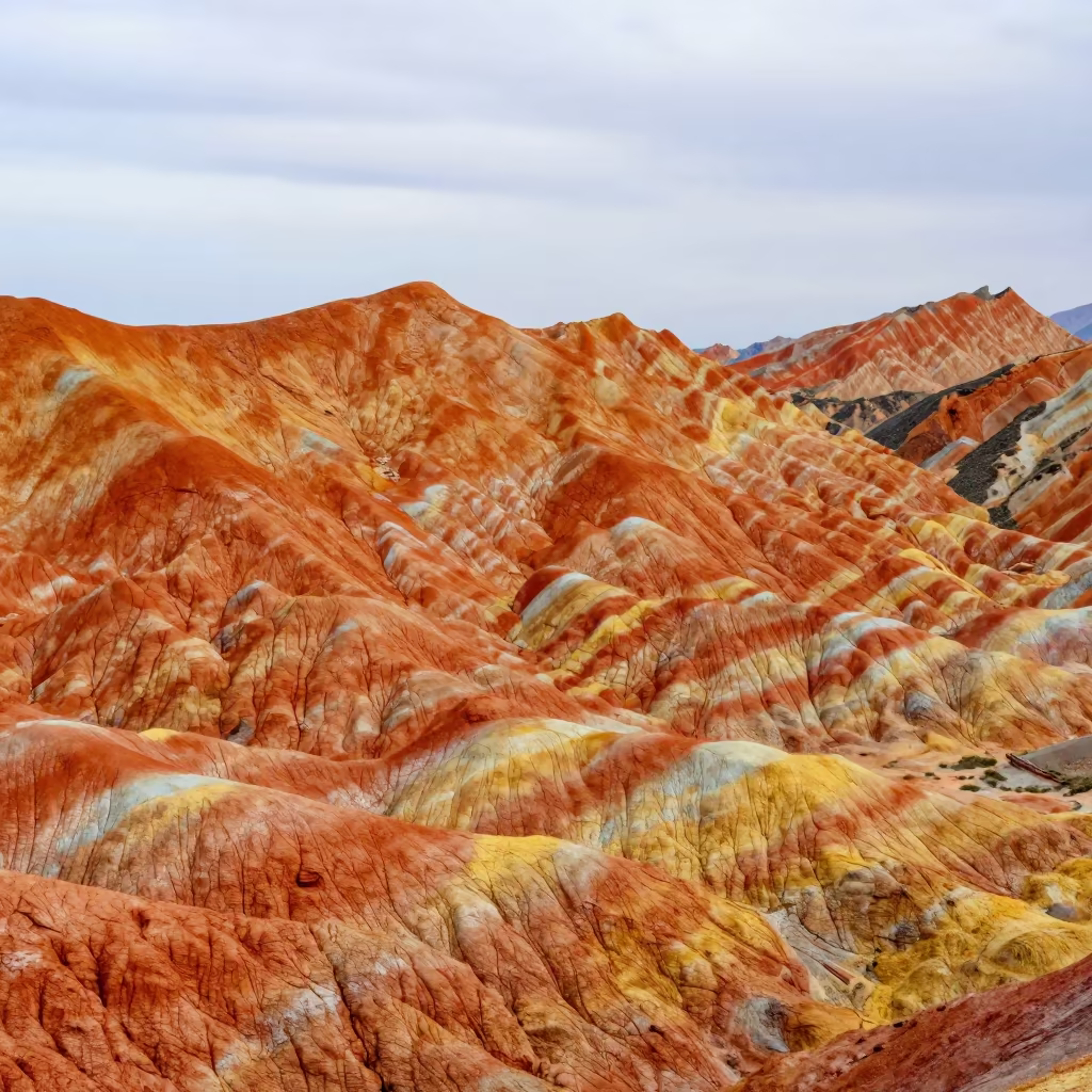 Zhangye Rainbow Ridges Under Fast Clouds in beneath fast-moving cloud bands near Luanda